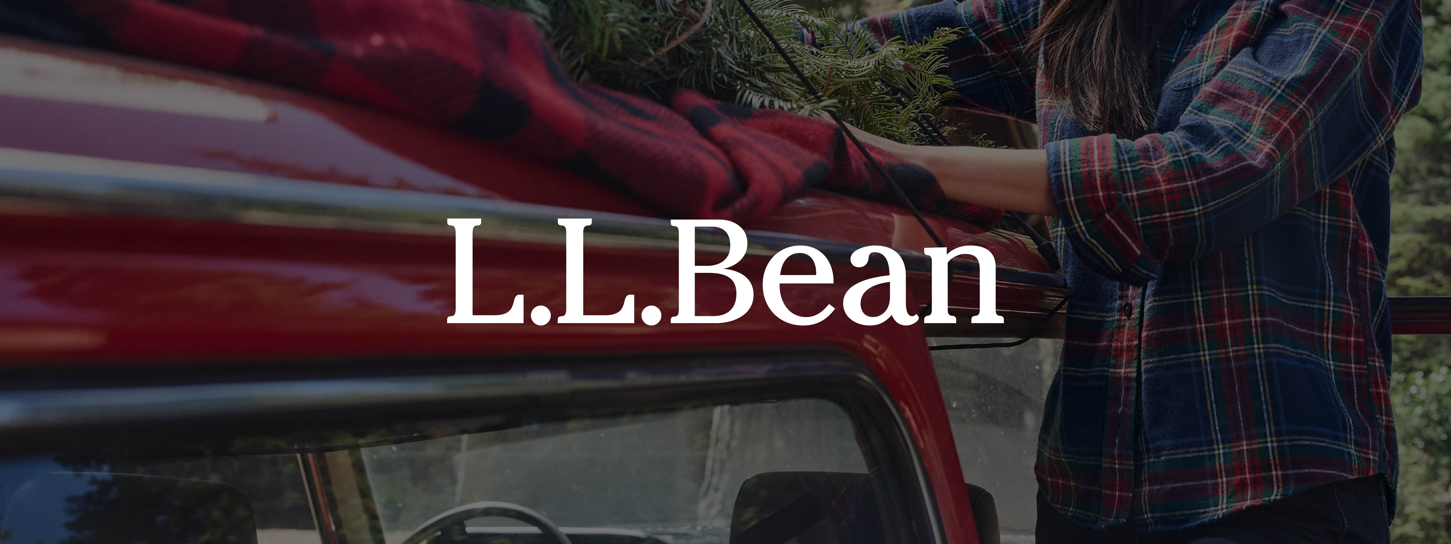 Woman outdoors wearing flannel strapping things to her car