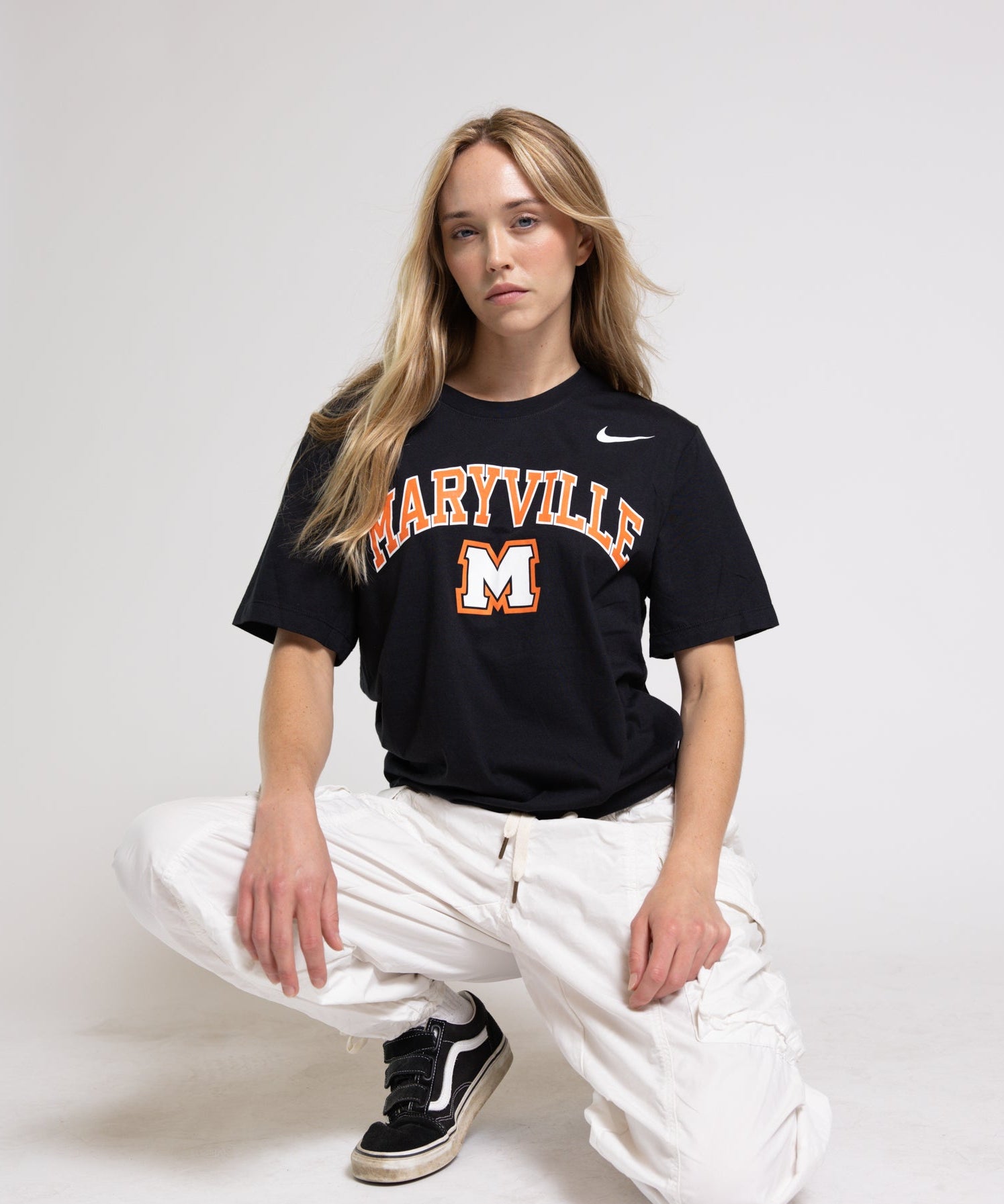 Woman wearing a black Maryville t-shirt against a white background