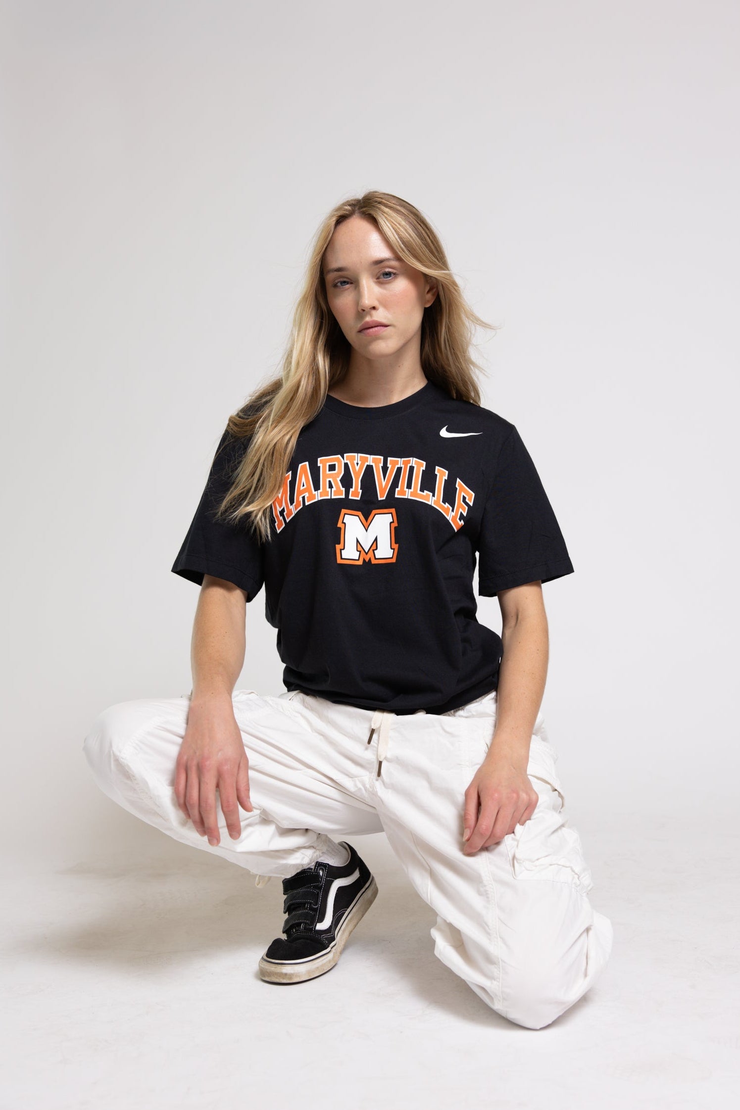 Woman wearing a black Maryville t-shirt against a white background